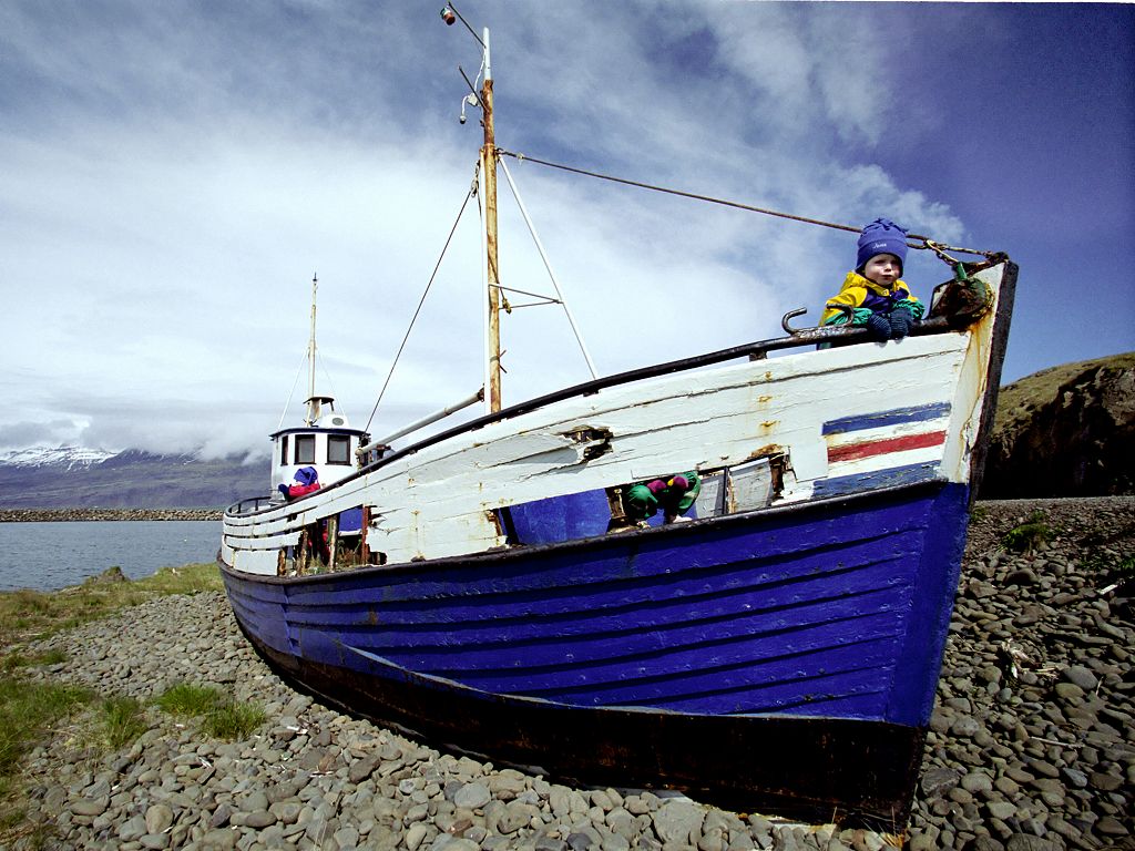Icelandic tot playing in a beached boat in Djúpivogur.  Click for next photo.