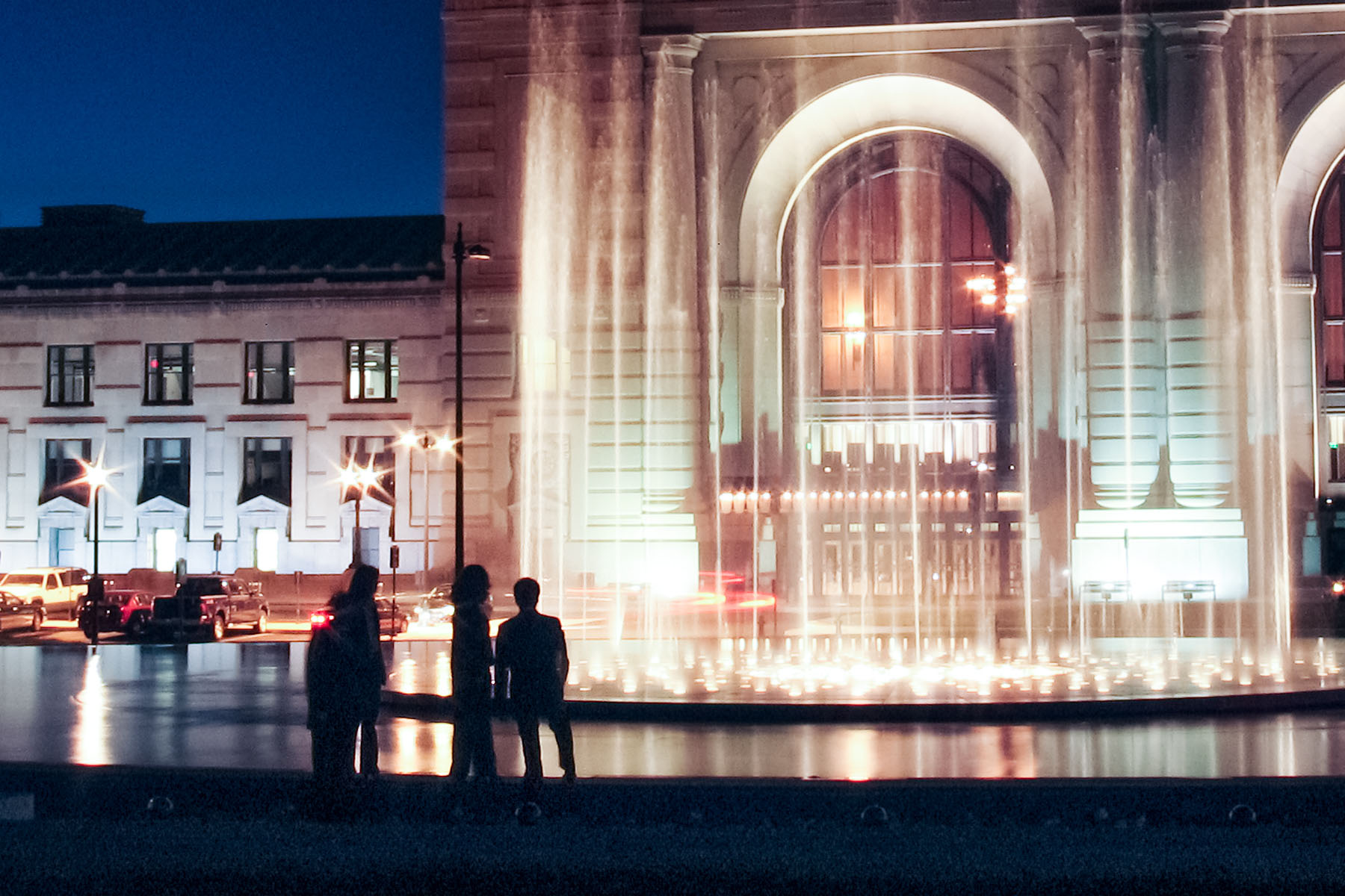 A group watches the fountain in front of Union Station, Kansas City, while waiting for a photographer (not me) to set up a shot.  Click for next photo.