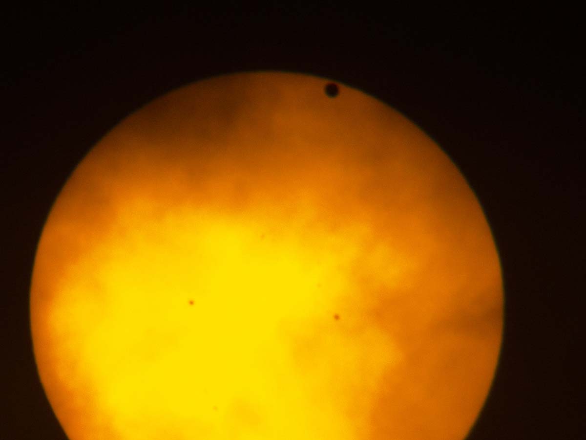 Transit of Venus, taken in New York City, June 5, 2012.  I was on extended assignment and didnt have my big scopes or camera, so I took this with a small handheld camera through my binoculars, which were covered by a solar filter.  I have some somewhat better photos from the 2004 transit.  Transits come in pairs separated by long gaps, so the next transit will not occur until 2117.  Click for next photo.