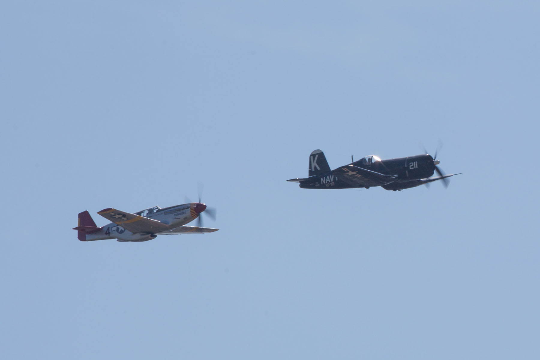 P-51 Mustang Red Tail chases F-4U Corsair, Sioux Falls Air Show, August 2019.  Click for next photo.