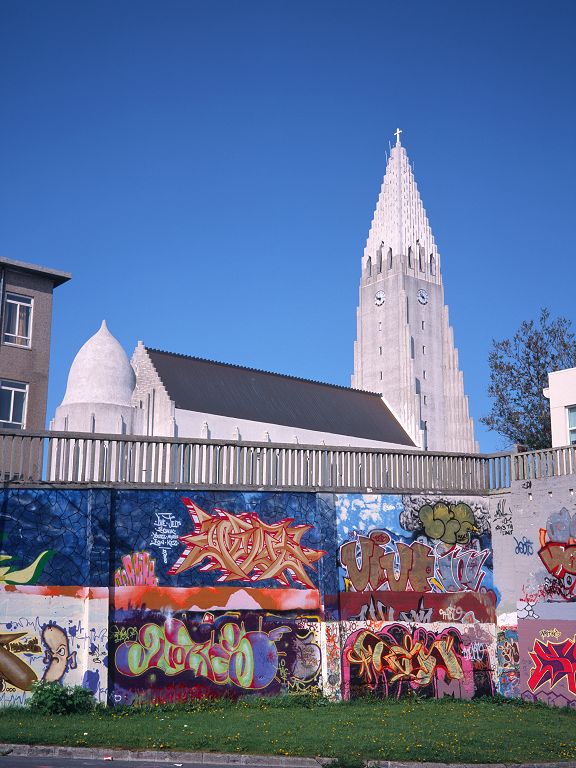Hallgrímskirkja looms above the colorful walls of a nearby parking lot.  Scanned from 6x9 medium format slide.  Click for next photo.