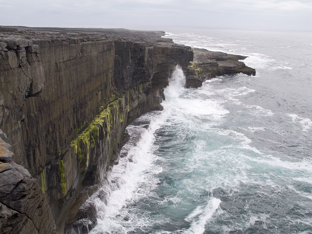 Atlantic waves thumping against the cliff, western Inis Meáin, Ireland.  Click for next photo.