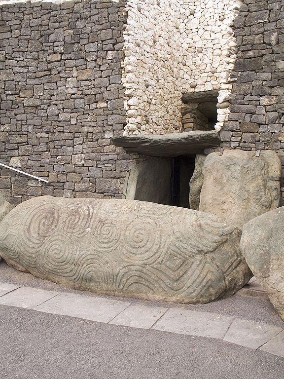 Carved stone and entrance to the Newgrange tomb, Ireland.  Click for next photo.