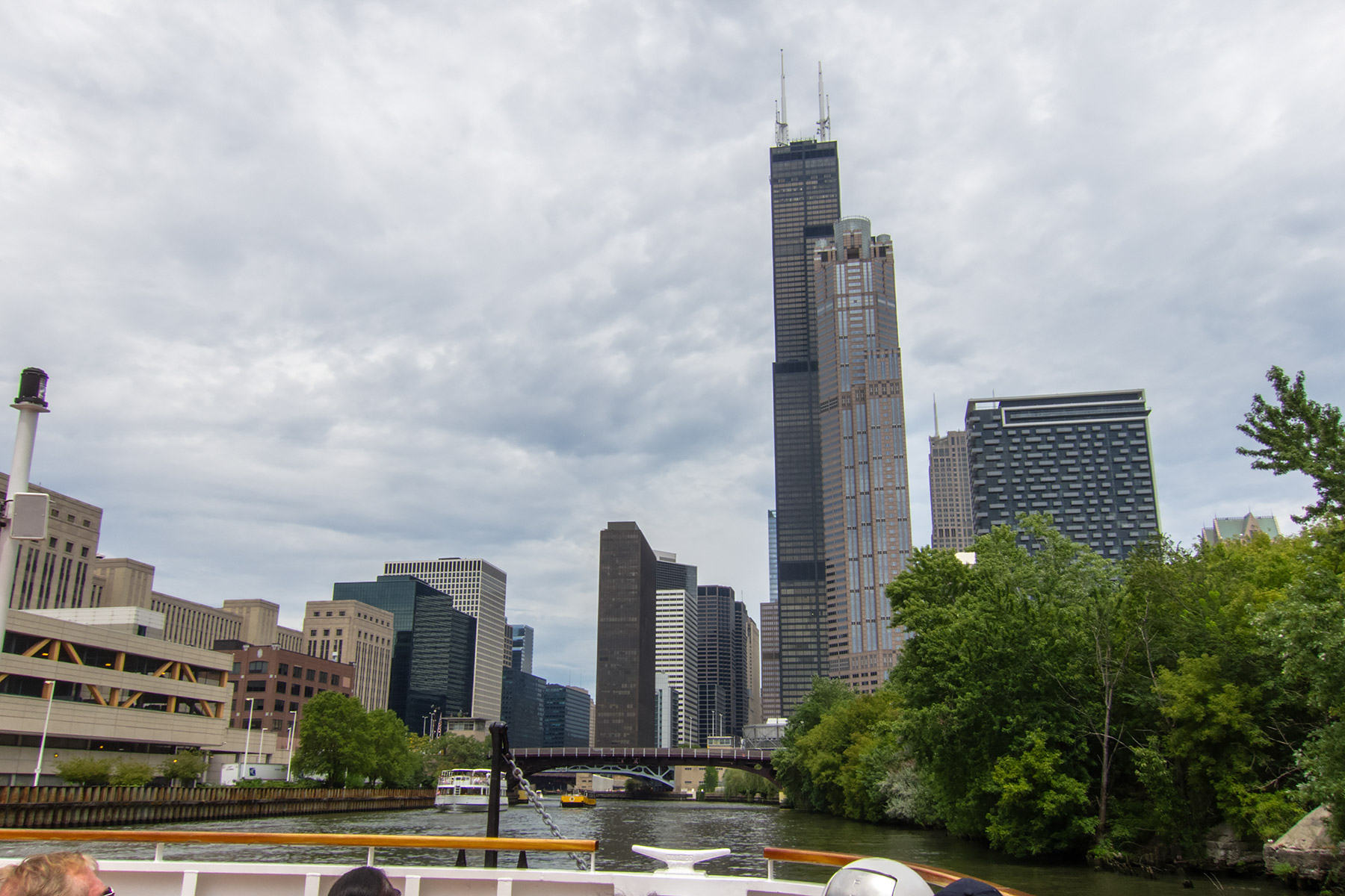 Willis Tower (formerly the Sears Tower), Chicago River boat tour.  For two years (2011-2013) I worked in the building across the river from the tower, the (relatively) tiny 30-story black building to the left of the bridge.  Click for next photo.