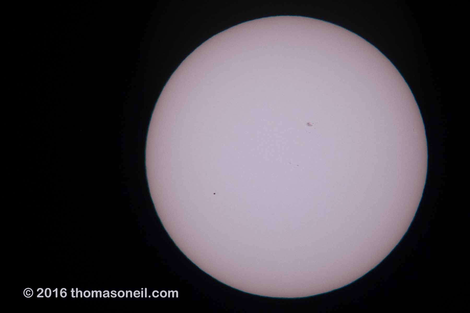 A bad image of the Transit of Mercury, May 9, 2016, shot with the old G6 camera through Televue 85 telescope.  Mercury is the dot toward the lower left.  The day was mostly cloudy/hazy and I was surprised to get anything at all.  For some of my better sun images, see the Partial Eclipse from 2014, the Transit of Venus from 2004, or the Annual Eclipse as seen from Iceland in 2003.  Click for next photo.