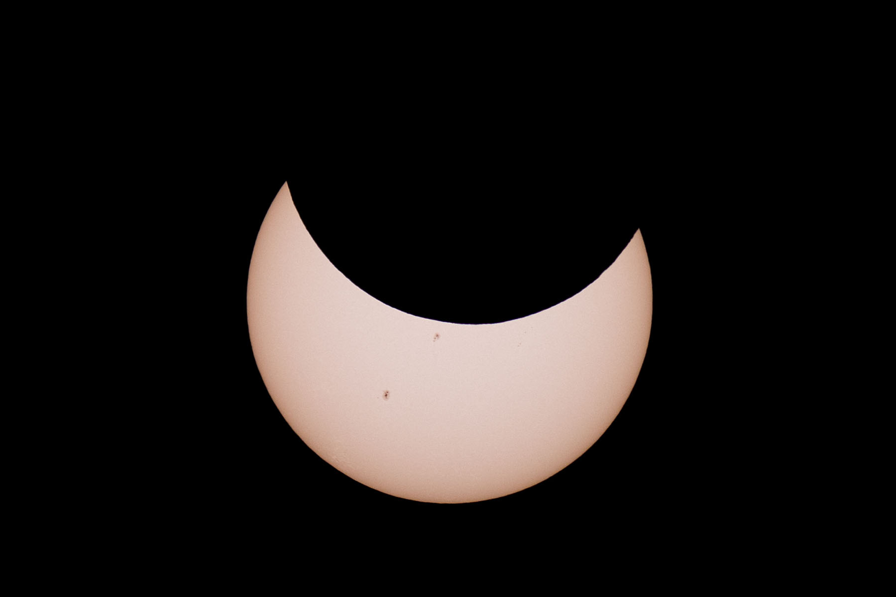 Annular solar eclipse, 39 minutes before peak.  Glass solar filter on Televue 85 telescope, Canon 6D Mark II camera on T-mount, 600mm F7 equivalent.  Click for next photo.