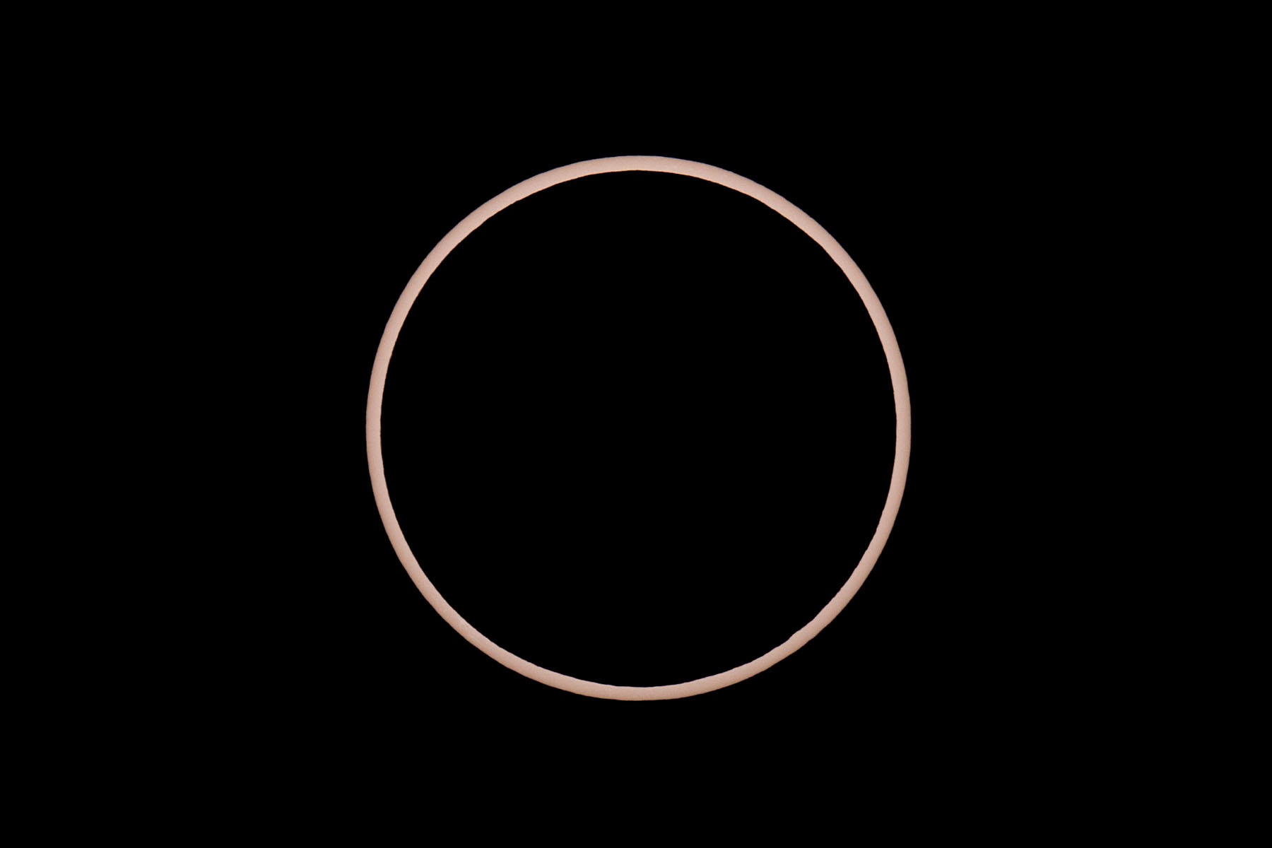 Annular solar eclipse, perfect annulus.  Glass solar filter on Televue 85 telescope, Canon 6D Mark II camera on T-mount, 600mm F7 equivalent.  Click for next photo.