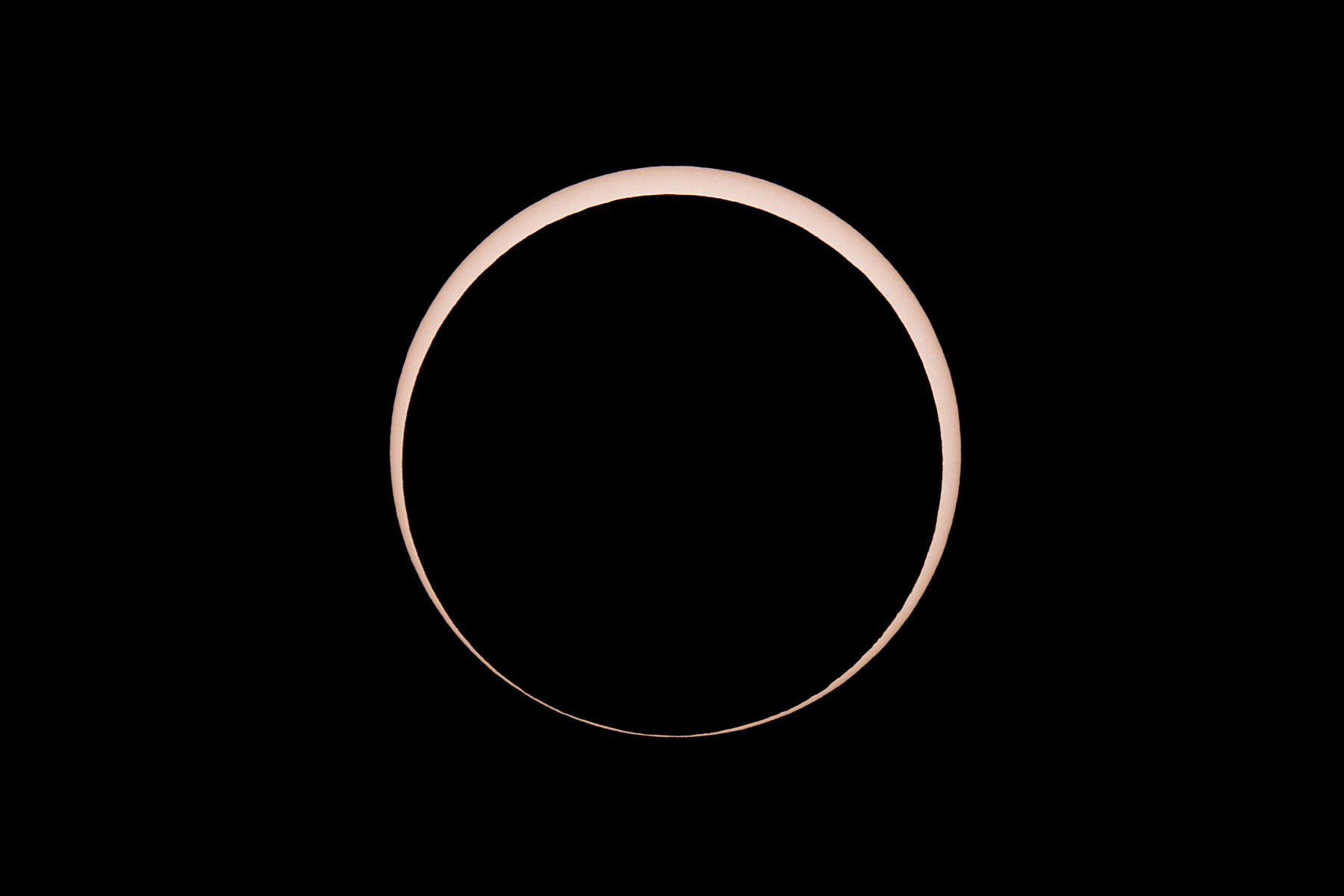 Annular solar eclipse, two minutes after peak.  Glass solar filter on Televue 85 telescope, Canon 6D Mark II camera on T-mount, 600mm F7 equivalent.  Click for next photo.