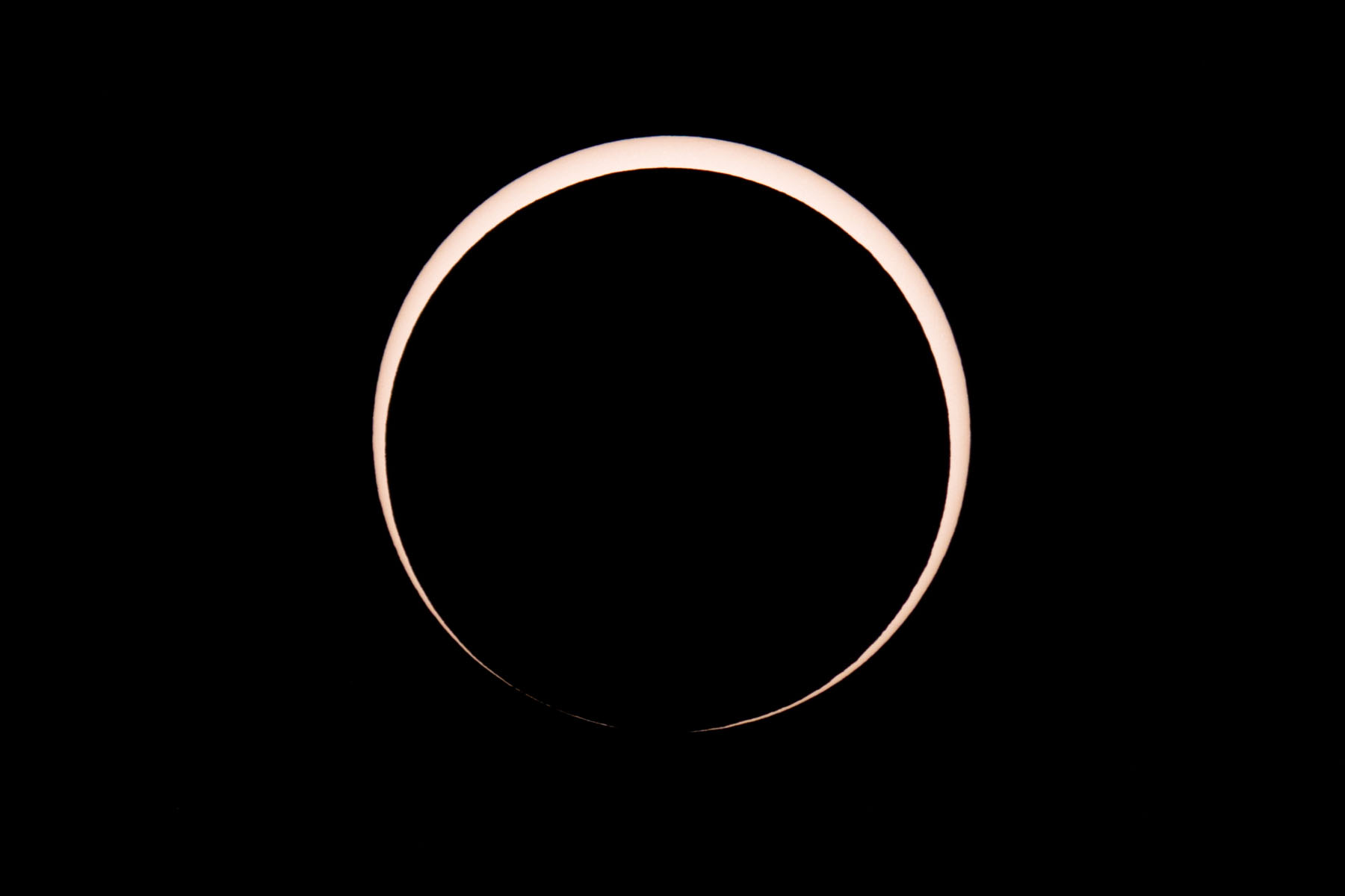 Annular solar eclipse, three minutes after peak.  Glass solar filter on Televue 85 telescope, Canon 6D Mark II camera on T-mount, 600mm F7 equivalent.  Click for next photo.