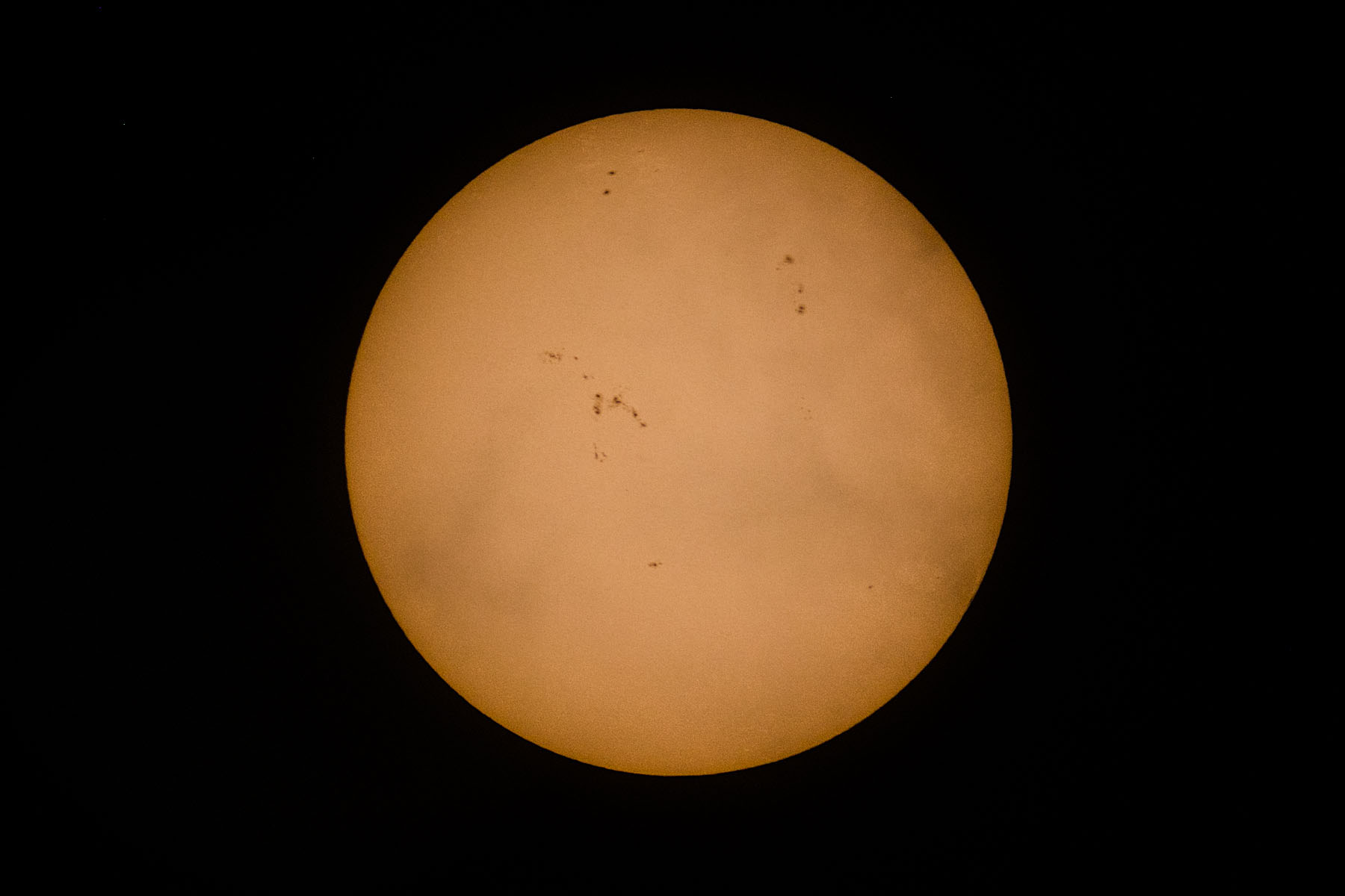 Two days after the previous image, trying out new T-mount and eyepiece adapter with some high clouds passing in front of the sun.  Shot through Televue telescope with M100 camera, prime focus.  Click for next photo.