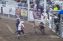XTreme Bulls, Red Lodge, July 1.  This is a fuzzy image but it shows bullfighter J.D. Harrell getting tossed 10 feet in the air.  When he came down he landed across the back of the bull before sliding off.  He popped right back up, and he must have been OK because he escaped the very next bull chasing him across the ring.  Note the expression on the ambulance driver.
